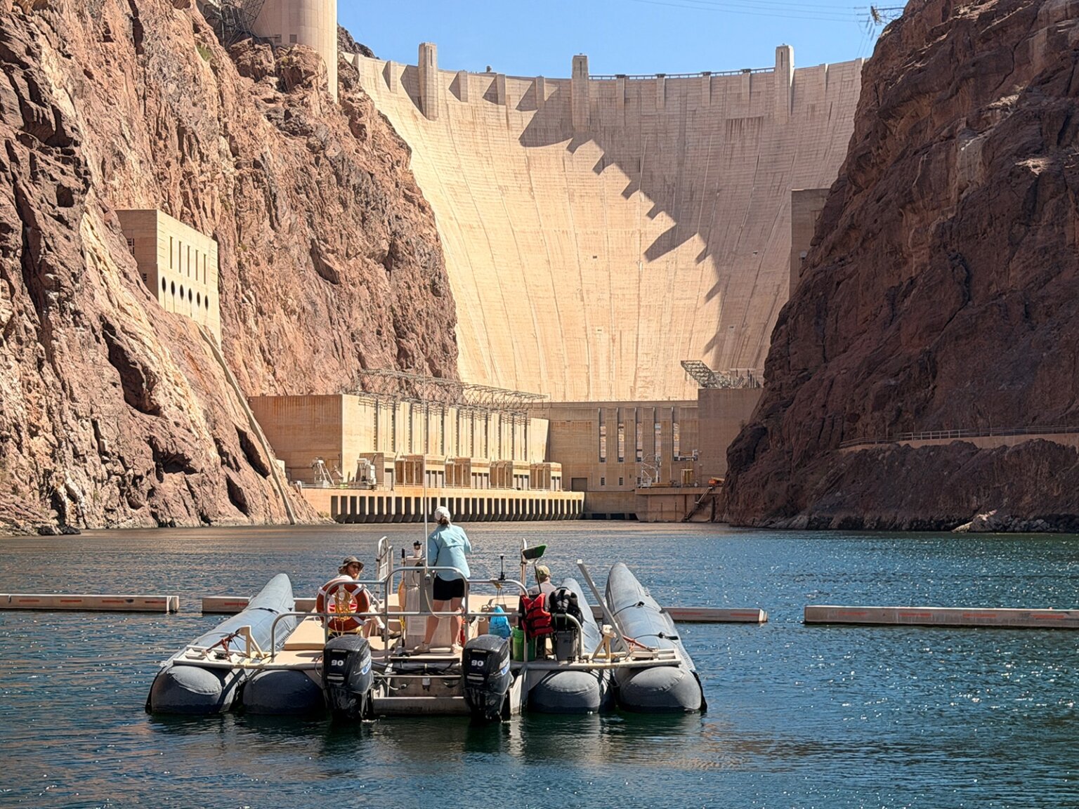 Raft with people on it facing the Hover Dam