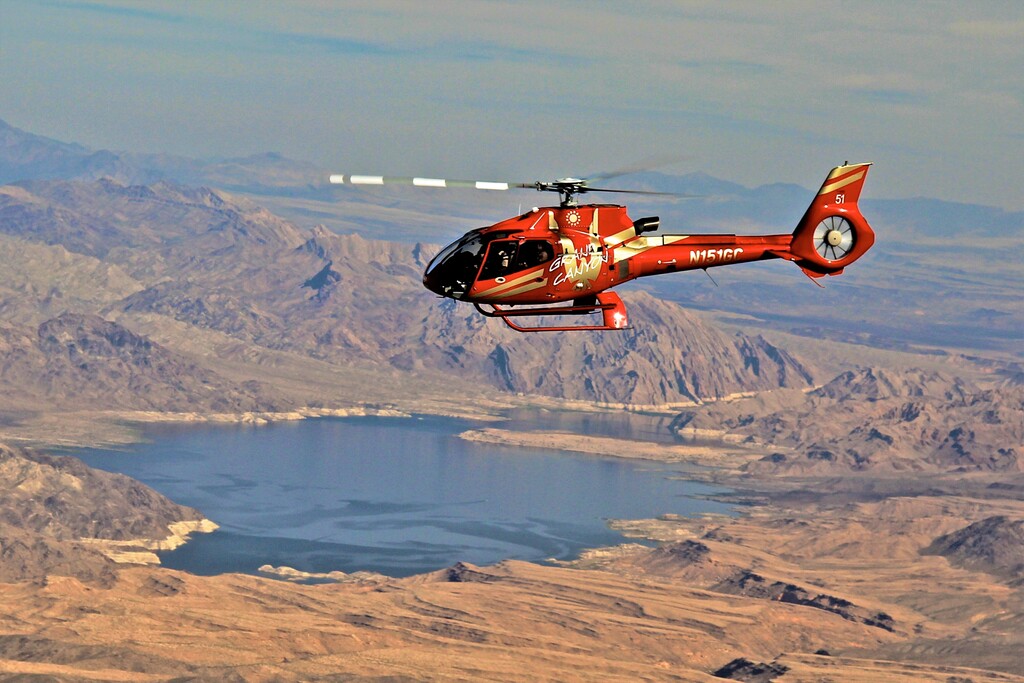 Helicopter flying over a lake
